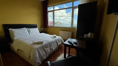 a bedroom with a bed and a window at Cosmopolitan Park Hotel in Istanbul