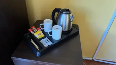 a tray with a coffee maker and cups on a table at Cosmopolitan Park Hotel in Istanbul