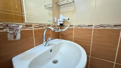 a bathroom with a white sink and a mirror at Cosmopolitan Park Hotel in Istanbul