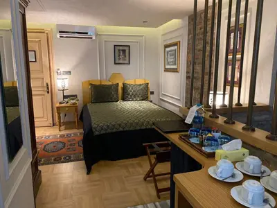 a hotel room with a bed and a table with dishes at Hotel Niles Istanbul in Istanbul