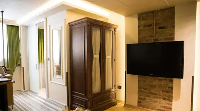 a living room with a large entertainment center with a flat screen tv at Hotel Niles Istanbul in Istanbul