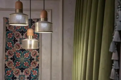 two lights hanging from a wall with green curtains at Hotel Niles Istanbul in Istanbul