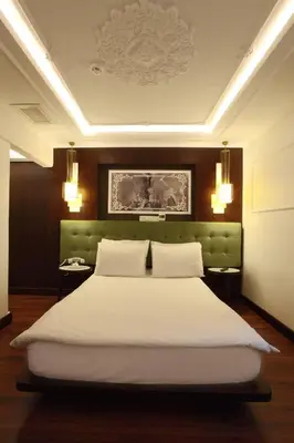 a bedroom with a large white bed with two pillows at Hotel Niles Istanbul in Istanbul