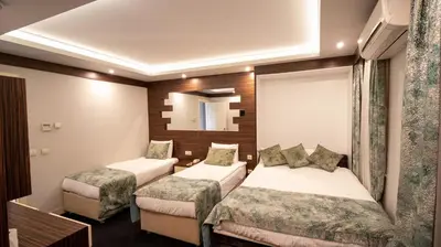 a hotel room with two beds and a mirror at Sogut Hotel Old City in Istanbul