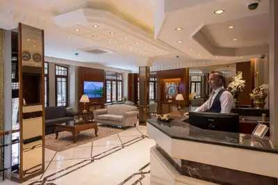 a man sitting at a bar in a salon at Vardar Palace Hotel - Special Category in Istanbul