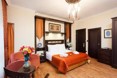 a hotel room with a bed and a chair at Ottoman Hotel Imperial-Special Category in Istanbul
