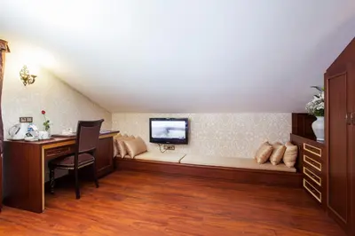 a room with a couch with a tv on the wall at Ottoman Hotel Imperial-Special Category in Istanbul