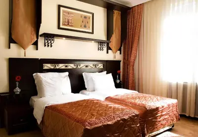 a bedroom with two beds with white pillows at Ottoman Hotel Imperial-Special Category in Istanbul