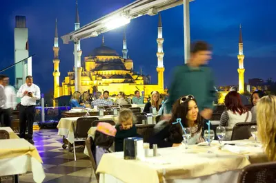 a restaurant with people sitting at tables in front of the blue mosque at Seven Hills Hotel - Special Category in Istanbul