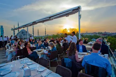 a group of people sitting at tables on a roof at Seven Hills Hotel - Special Category in Istanbul