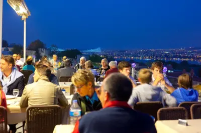 a crowd of people sitting at tables at night at Seven Hills Hotel - Special Category in Istanbul