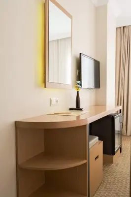 a room with a desk with a computer and a mirror at Sude Konak in Istanbul