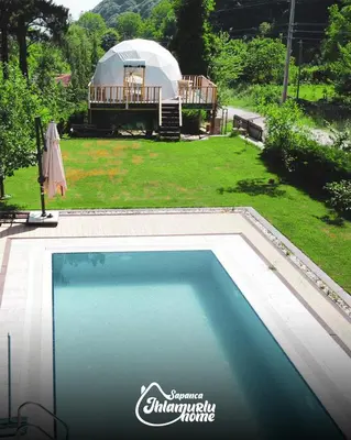 a swimming pool in front of a yurt with a tent at Ihlamurlu Home in Sapanca