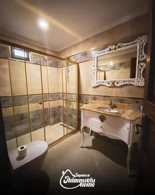 a bathroom with a sink and a toilet and a mirror at Ihlamurlu Home in Sapanca