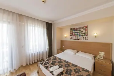 a hotel room with a bed and a large window at Deniz Houses in Istanbul