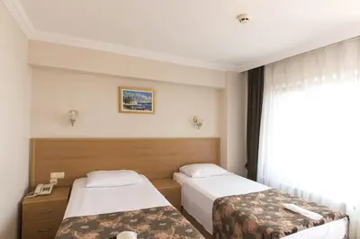 a hotel room with two beds and a window at Deniz Houses in Istanbul