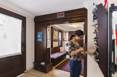 a woman standing in front of a door at Deniz Houses in Istanbul
