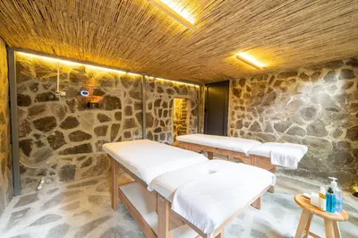 a room with three beds in a stone wall at Miss Royal Hotel & SPA in Istanbul