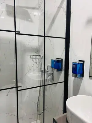 a white bathroom with a shower and a sink at Miss Royal Hotel & SPA in Istanbul
