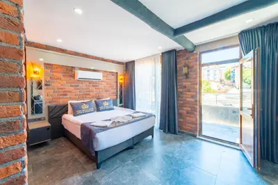 a bedroom with a bed and a brick wall at Miss Royal Hotel & SPA in Istanbul