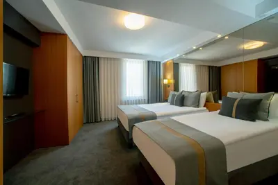 a hotel room with two beds and a television at Tan Hotel - Special Category in Istanbul