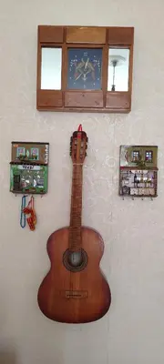 a wooden guitar hanging on a wall at Nur home1 in Istanbul