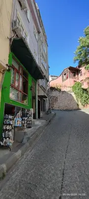 a green building on a street next to a building at Nur home1 in Istanbul
