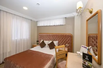 a hotel room with a bed and a mirror at Grand Anka Hotel in Istanbul