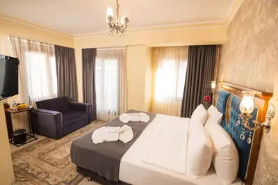 a hotel room with a bed and a chair at A'la Sofia Hotel İstanbul in Istanbul