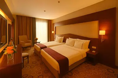 a hotel room with a large bed and a desk at Taksim Gonen Hotel in Istanbul