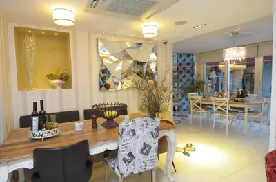 a living room with a table and a dining room at Taksim Gonen Hotel in Istanbul