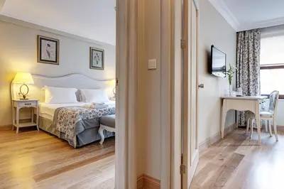 a bedroom with a bed and a table and a desk at Arena Hotel - Special Class in Istanbul