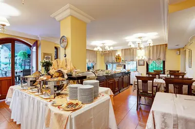 a large kitchen with tables with plates on it at Arena Hotel - Special Class in Istanbul