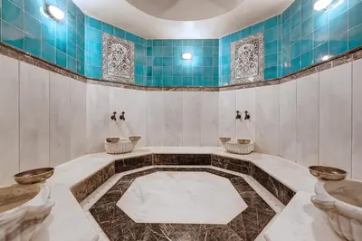 a bathroom with two sinks and a blue tiled wall at Arena Hotel - Special Class in Istanbul