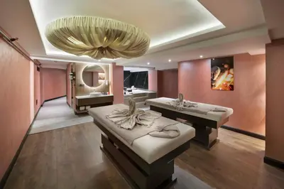 a bathroom with two sinks and a large chandelier at Orka Royal Hotel & Spa in Istanbul