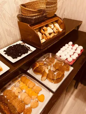 a table filled with different types of bread and pastries at Adora Hotel in Istanbul