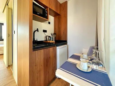 a small kitchen with a table and a counter at Sultan Pier Hotel in Istanbul