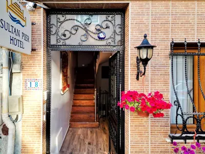 an entrance to a building with a staircase and flowers at Sultan Pier Hotel in Istanbul