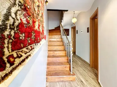 a staircase in a house with a rug on the wall at Sultan Pier Hotel in Istanbul