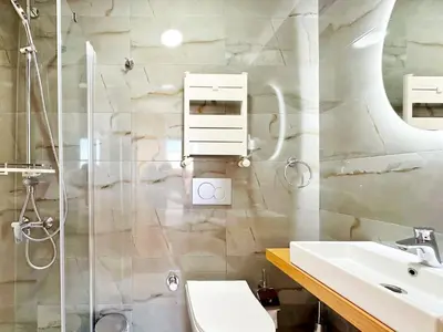 a bathroom with a shower and a toilet and a sink at Sultan Pier Hotel in Istanbul