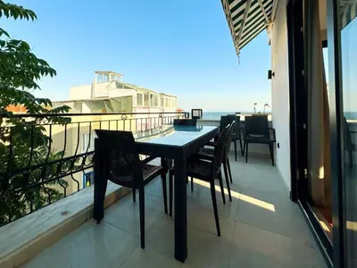 a table and chairs on a balcony with the ocean at Sultan Pier Hotel in Istanbul