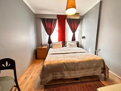 a bedroom with a large bed and a window at Ahmet Efendi Evi in Istanbul