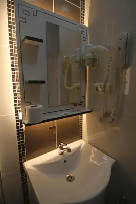 a bathroom with a white sink and a mirror at Grand Liza Hotel in Istanbul