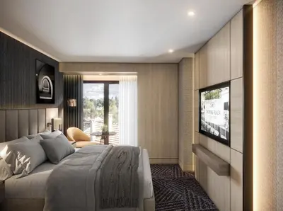 a bedroom with a large bed and a flat screen tv at Crowne Plaza Istanbul - Ortakoy Bosphorus by IHG in Istanbul