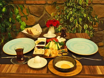 a wooden table with plates of food on it at The Sunrise Hotel in Istanbul