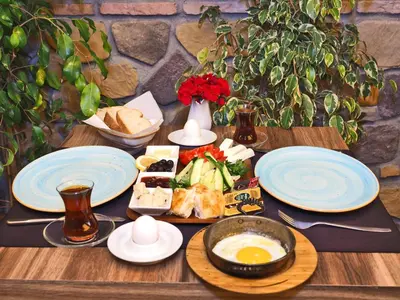 a wooden table with plates of food on it at The Sunrise Hotel in Istanbul