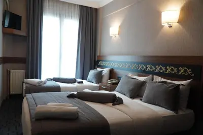 a hotel room with two beds and a window at Bern Hotel in Istanbul