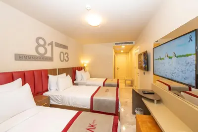 a hotel room with two beds and a flat screen tv at Ramada By Wyndham Istanbul Pera Taksim in Istanbul