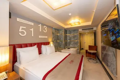 a hotel room with a bed and a bathroom at Ramada By Wyndham Istanbul Pera Taksim in Istanbul