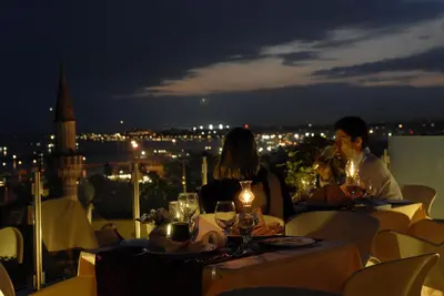 a group of people sitting at a table with wine glasses at Hotel Daphne in Istanbul